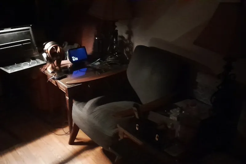 jovem adulto brasileiro entregando encomenda na porta sobre “Carnê-leão: o que é e como funciona durante o ano” com fones e notebook em escr