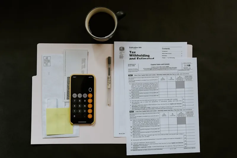 aposentado brasileiro anotando compras do mês sobre “Exemplo numérico com R$ 490,00 por mês” com cartão de crédito e smartphone em loja pequ